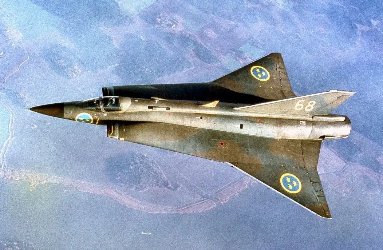 Saab Draken, ett ikoniskt exempel p&aring; svenska stridsflygplan genom tiderna, flyger &ouml;ver ett landskap.